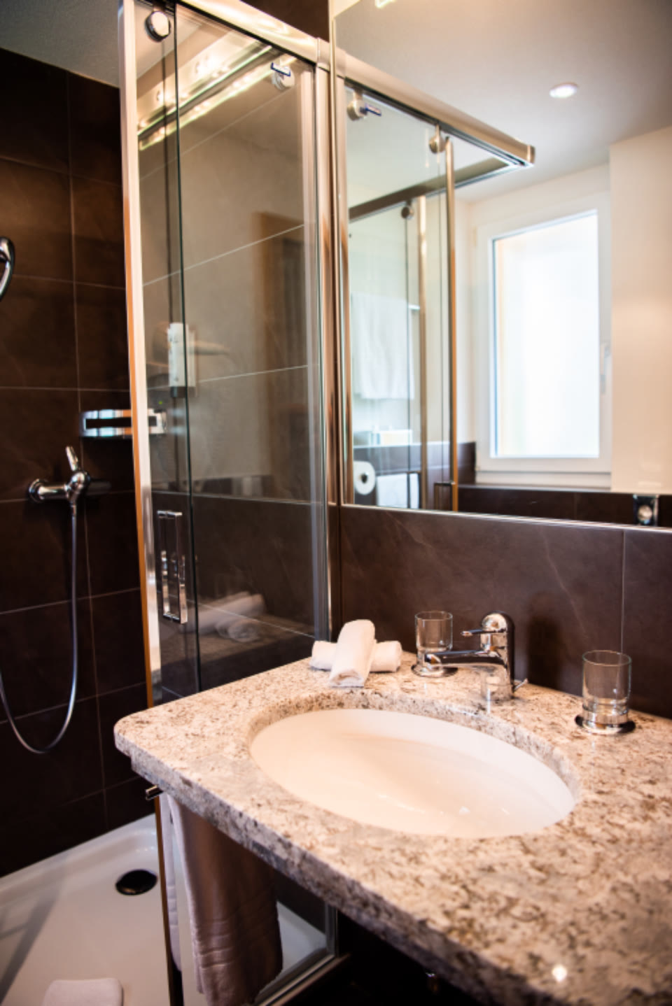 Renovated bathroom with stone vanity and glass shower screen