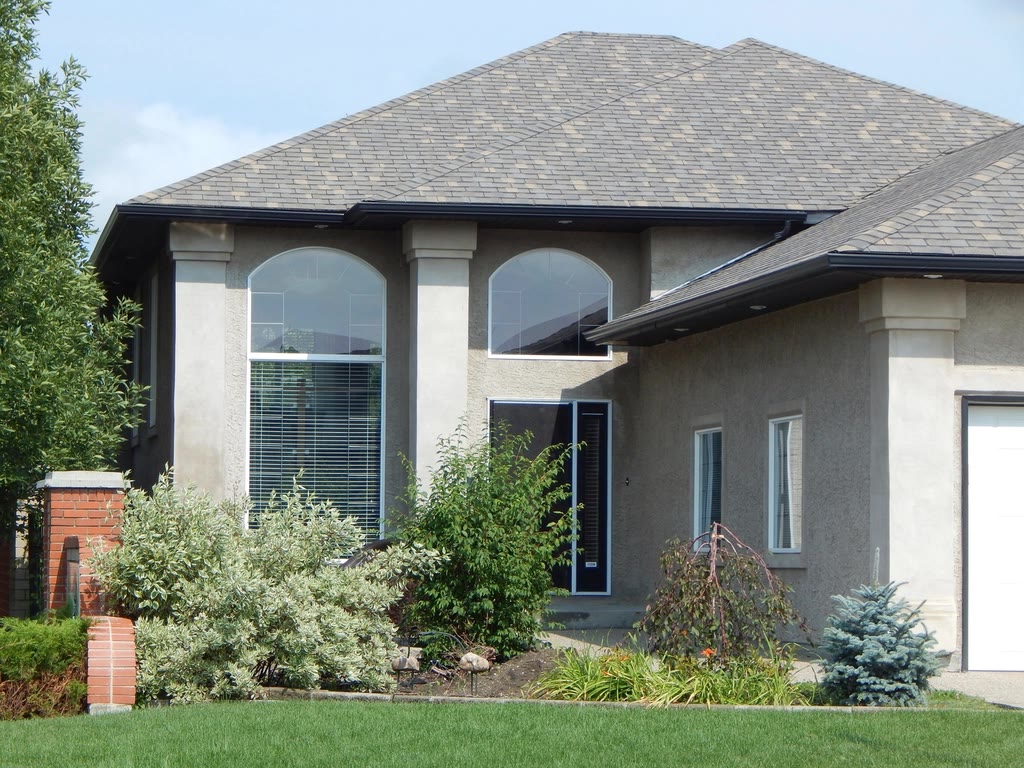 Newly completed rendered family home with arched windows